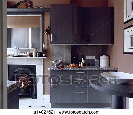 Modern pale brown kitchen with grey fitted cupboard beside open door to livingroom View Large Photo Image Stock Image - Modern pale brown kitchen with grey fitted cupboard beside open door to livingroom. Fotosearch