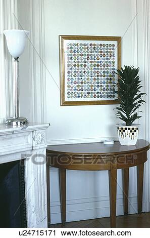 Modern picture above houseplant on console table View Large Photo Image Stock Image - Modern picture above houseplant on console table. Fotosearch