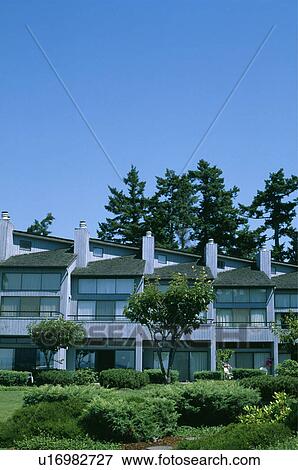 Stock Photo - Modern white apartment building in the country. Fotosearch