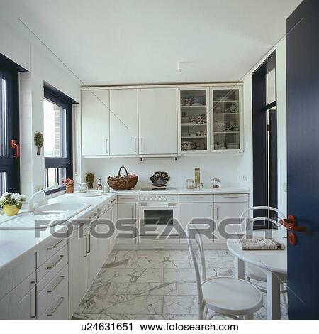 Modern white kitchen diner with marble tiled floor View Large Photo Image Stock Image - Modern white kitchen diner with marble tiled floor. Fotosearch
