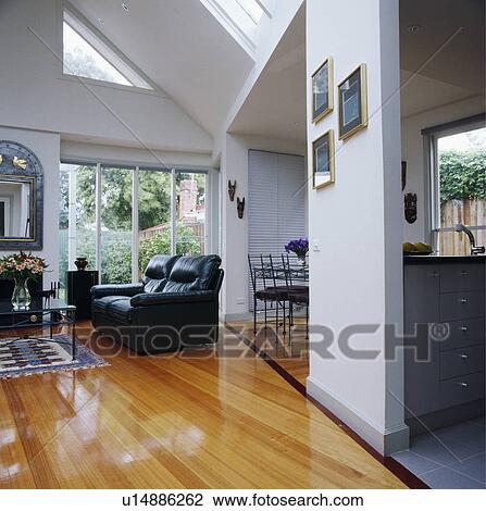 Stock Image - Modern white living room with wooden flooring. Fotosearch