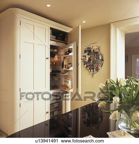 Neutral cupboard with built-in refrigerator and freezer in modern country kitchen View Large Photo Image Stock Image - Neutral cupboard with built-in refrigerator and freezer in modern country kitchen. Fotosearch