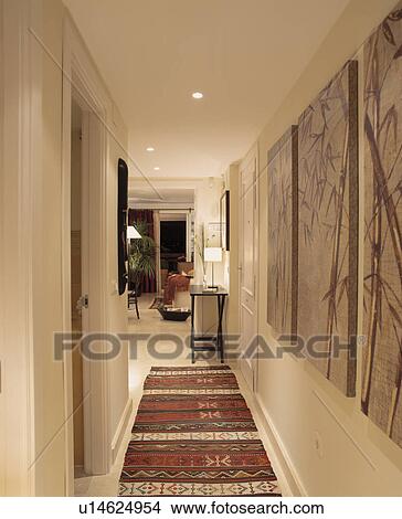 Picture - Oriental pictures and rugs on floor of modern white hall corridor. Fotosearch