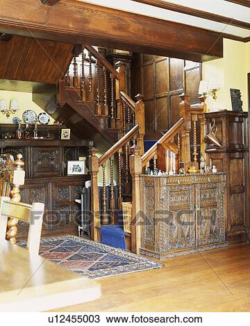 Ornate carved cupboards at foot of wooden staircase in country hall View Large Photo Image Stock Image - Ornate carved cupboards at foot of wooden staircase in country hall. Fotosearch