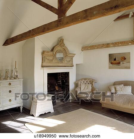 Ornate carved mirror above fireplace in contemporary cream living room with apex ceiling View Large Photo Image Stock Image - Ornate carved mirror above fireplace in contemporary cream living room with apex ceiling. Fotosearch