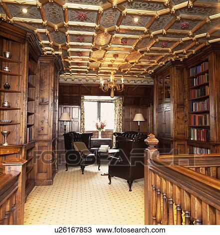 Ornate gilt and painted ceiling in landing library with wooden bookcases and leather armchairs on cream carpet View Large Photo Image Stock Image - Ornate gilt and painted ceiling in landing library with wooden bookcases and leather armchairs on cream carpet. Fotosearch