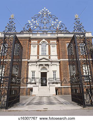 Ornate wrought iron gates in front of large Georgian house View Large Photo Image Stock Photo - Ornate wrought iron gates in front of large Georgian house. Fotosearch