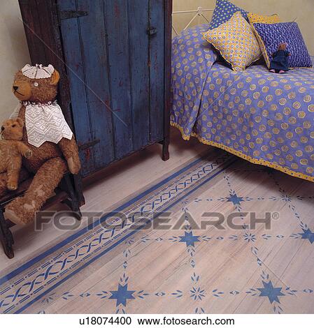 Painted faux rug on floor of child's bedroom with painted cupboard. View Large Photo Image Stock Image - Painted faux rug on floor of child's bedroom with painted cupboard.. Fotosearch