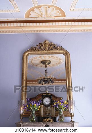 Picture - Painted freize on ceiling above gilt overmantel mirror . Fotosearch