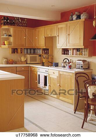 Stock Photo - Pale wood modern kitchen with limestone floor tiles. Fotosearch
