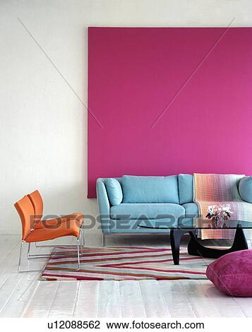 Pastel blue sofa against bright pink picture in modern living room View Large Photo Image Stock Image - Pastel blue sofa against bright pink picture in modern living room. Fotosearch