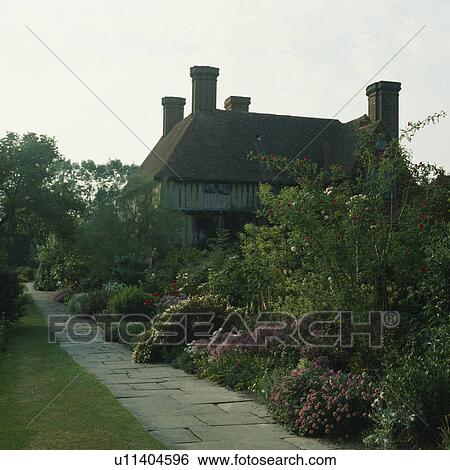 Path beside herbaceous border in large country garden in summer View Large Photo Image Stock Photograph - Path beside herbaceous border in large country garden in summer. Fotosearch