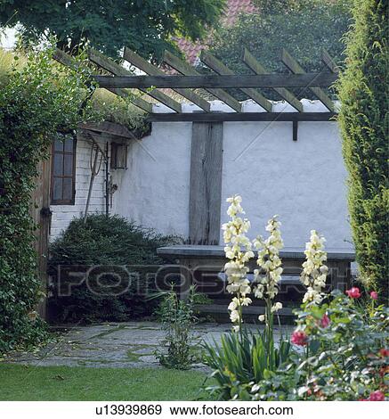 Patio below pergola in country garden in summer View Large Photo Image Stock Photo - Patio below pergola in country garden in summer. Fotosearch