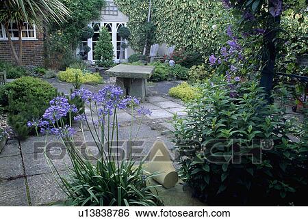 Stock Photograph - Patio in country garden in summer. Fotosearch