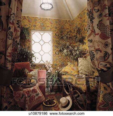 Stock Photograph - Patterned wallpaper and furniture in living room. Fotosearch