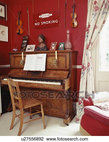 Piano in traditional red living room View Large Photo Image Stock Image - Piano in traditional red living room. Fotosearch