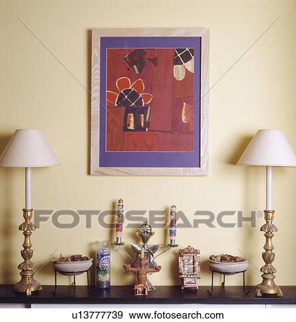 Picture above brass lamps with white shades on shelf with ethnic candlesticks View Large Photo Image Stock Photo - Picture above brass lamps with white shades on shelf with ethnic candlesticks. Fotosearch