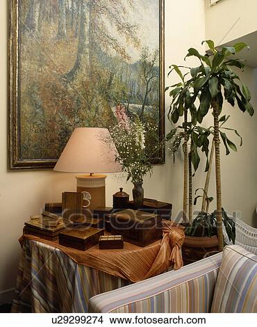 Picture above lighted lamp on table with collection of wooden antique boxes View Large Photo Image Picture - Picture above lighted lamp on table with collection of wooden antique boxes. Fotosearch