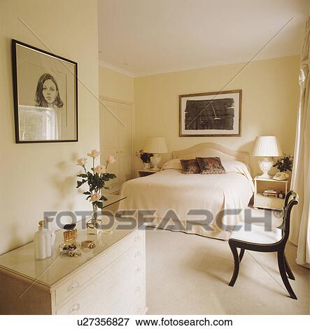 Picture above painted cream chest-of-drawers in neutral bedroom with cream carpet and bedcover View Large Photo Image Stock Photo - Picture above painted cream chest-of-drawers in neutral bedroom with cream carpet and bedcover. Fotosearch