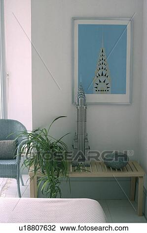 Stock Image - Picture of The Chrysler Building in New York above identical model building on low wooden table. Fotosearch