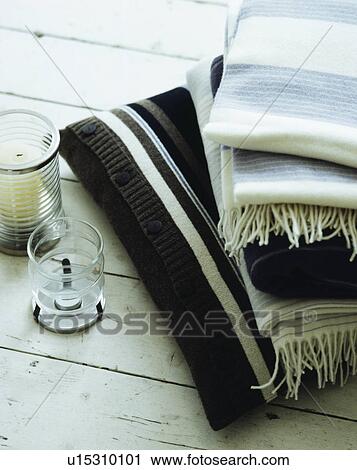 Pile of striped wool throws on limed floorboards View Large Photo Image Stock Image - Pile of striped wool throws on limed floorboards. Fotosearch