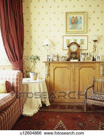 Pine cupboard and star-patterned wallpaper in tradtional living room View Large Photo Image Stock Photograph - Pine cupboard and star-patterned wallpaper in tradtional living room. Fotosearch