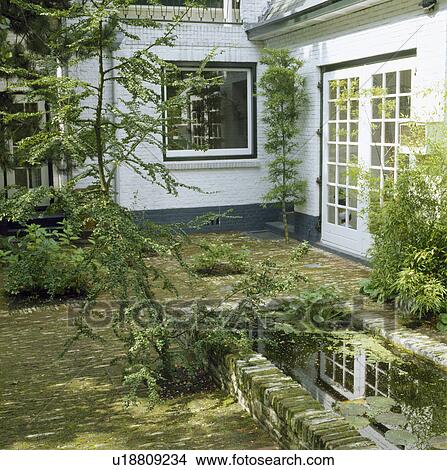 Pond and paving in town garden View Large Photo Image Picture - Pond and paving in town garden. Fotosearch