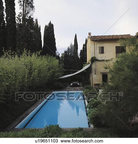 Rectangular swimming pool in garden of Italian country villa View Large Photo Image Stock Image - Rectangular swimming pool in garden of Italian country villa. Fotosearch