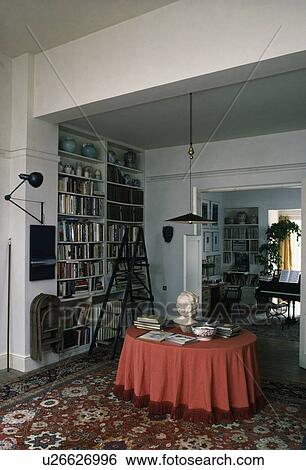 Red cloth on table in sixties dining room with stepladder and bookshelves View Large Photo Image Stock Photograph - Red cloth on table in sixties dining room with stepladder and bookshelves. Fotosearch