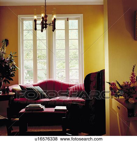 Red sofa in traditional yellow living room View Large Photo Image Stock Photo - Red sofa in traditional yellow living room. Fotosearch