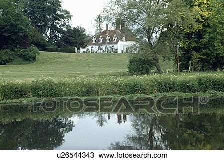 River and large lawn in front of traditional white country house View Large Photo Image Stock Image - River and large lawn in front of traditional white country house. Fotosearch