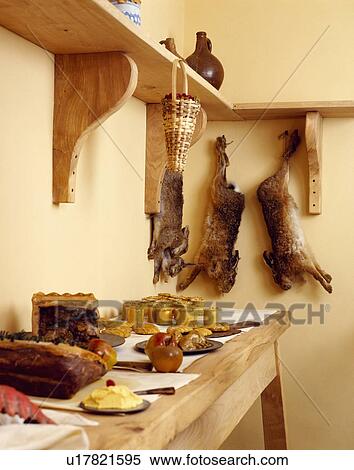 Shelf with rabbit above pies on wooden table View Large Photo Image Stock Photography - Shelf with rabbit above pies on wooden table. Fotosearch