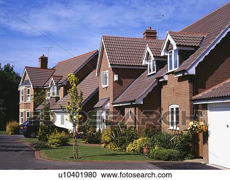 Sideways view of small newbuild detached brick houses View Large Photo Image Stock Image - Sideways view of small newbuild detached brick houses . Fotosearch