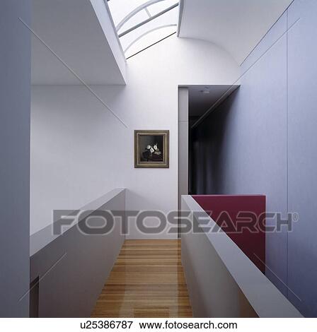 Stock Photo - Skylight above landing with wooden flooring on narrow walkway. Fotosearch