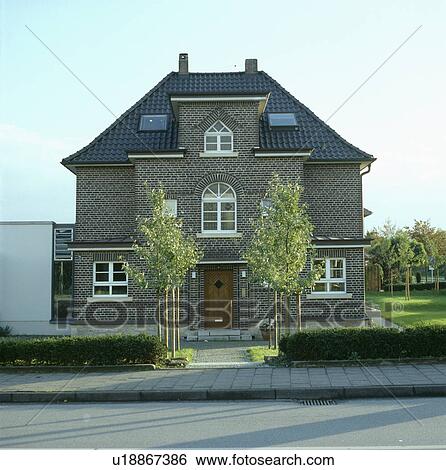 Small trees in front of large detached traditional house View Large Photo Image Stock Photograph - Small trees in front of large detached traditional house. Fotosearch