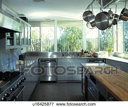 Stainless steel oven and dishwasher in modern white kitchen with grey floor tiles View Large Photo Image Stock Photo - Stainless steel oven and dishwasher in modern white kitchen with grey floor tiles. Fotosearch