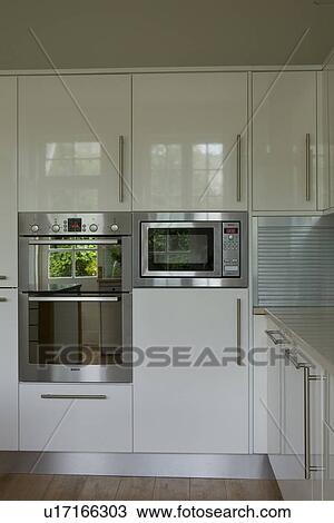 Stainless steel oven and microwave in modern white kitchen View Large Photo Image Stock Image - Stainless steel oven and microwave in modern white kitchen. Fotosearch
