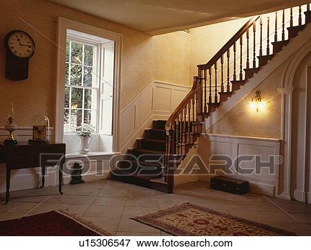 Stock Photo - Staircase and large traditional hall with sash window. Fotosearch