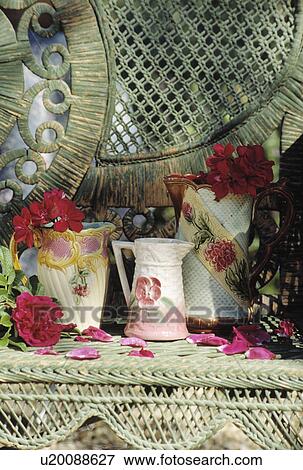 Stock Photo - Still-Life of antique jugs on wicker chair. Fotosearch