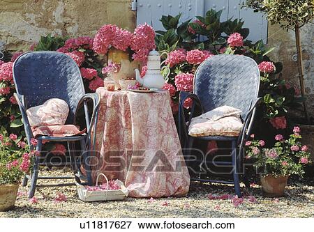 Still-Life of blue chairs and table with pink+white cloth View Large Photo Image Stock Photo - Still-Life of blue chairs and table with pink+white cloth. Fotosearch