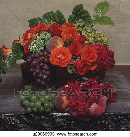 Stock Image - Still-Life of red roses and grapes. Fotosearch