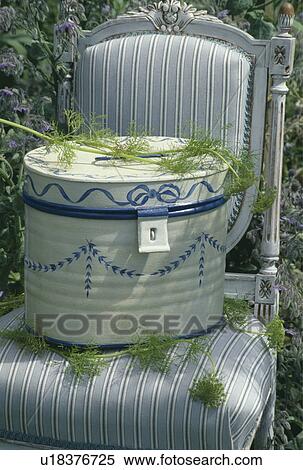 Stock Photography - Still-Life of tin box on chair. Fotosearch
