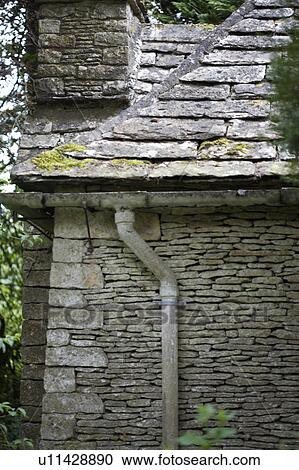 Stone walls with drainpipe and roof slates on old country cottage View Large Photo Image Stock Image - Stone walls with drainpipe and roof slates on old country cottage. Fotosearch