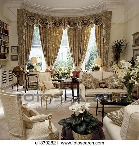 Swagged curtains in traditional town living room View Large Photo Image Stock Image - Swagged curtains in traditional town living room. Fotosearch