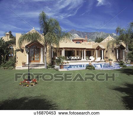 Stock Image - Swimming pool in front of large modern villa in Southern Spain. Fotosearch