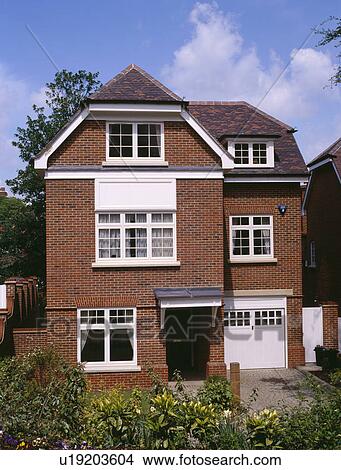 Three storey detached newbuild brick house with integral garage View Large Photo Image Picture - Three storey detached newbuild brick house with integral garage. Fotosearch