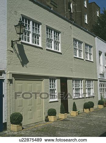 Stock Photo - Traditional terraced town house with integral garage. Fotosearch