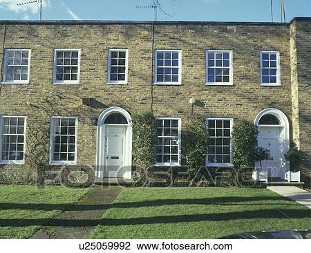 Stock Image - Traditional terraced town houses with lawns. Fotosearch