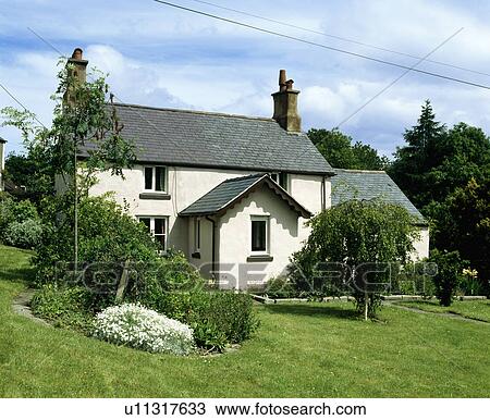 Stock Image - Traditional white Victorian country cottage. Fotosearch