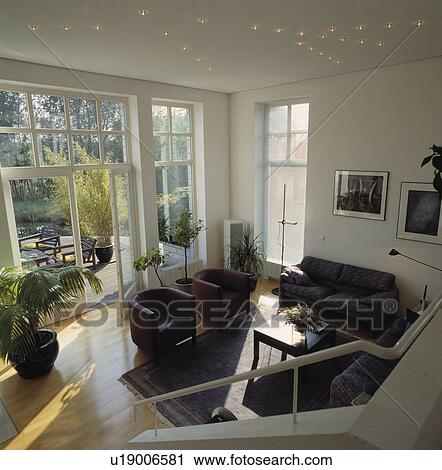 Tub armchairs in white living room with wooden flooring and French doors View Large Photo Image Stock Image - Tub armchairs in white living room with wooden flooring and French doors. Fotosearch